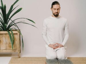 A man sitting with closed eyes practicing inner reflection and mindfulness