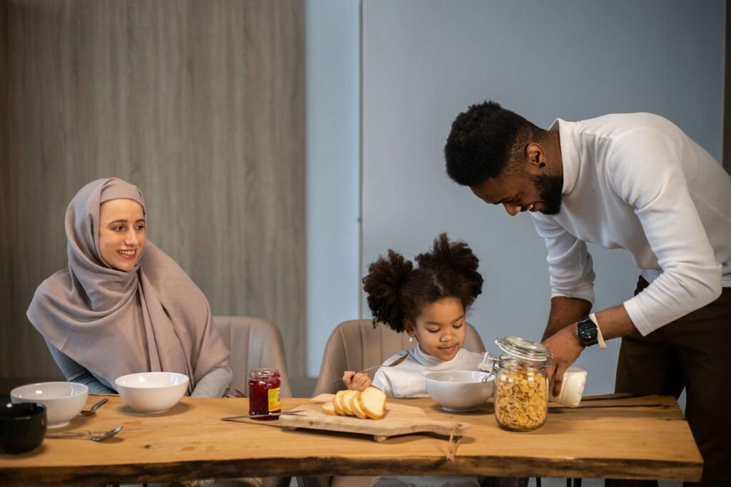 Ultimate Nutrition Guide visual showing a happy family—mother, father, and child—where the father is giving a glass of milk to his smiling daughter, promoting healthy nutrition habits.