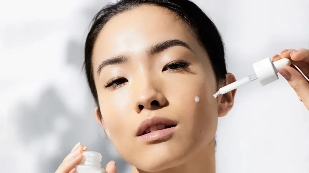Woman applying a skincare serum with a dropper, representing how SkinPres T enhances modern skincare routines at home.