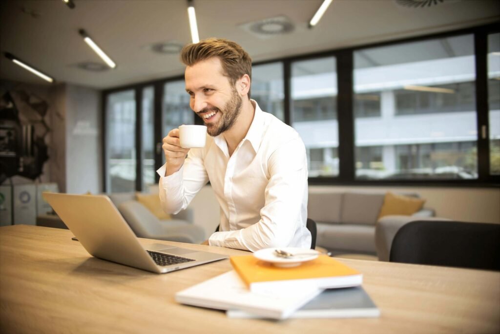 Man working on laptop in a modern office, symbolizing digital productivity with Skystta.com