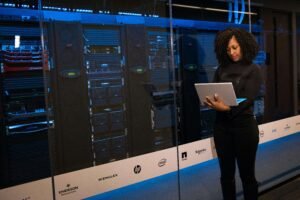 IT professional using laptop in secure data center – representing Software Keepho5ll cybersecurity solution