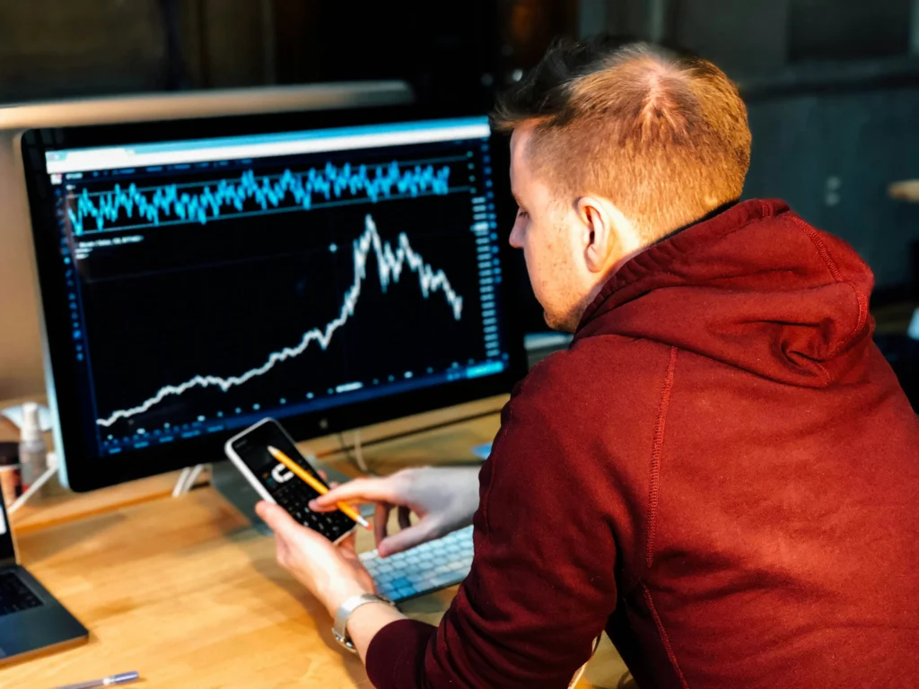 Analyst looking at stock market performance charts and 5-star ratings