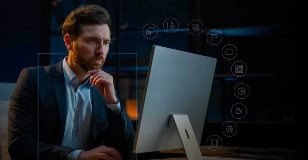 Man using desktop surrounded by app icons, representing Troozer.com’s all-in-one digital platform for modern online life