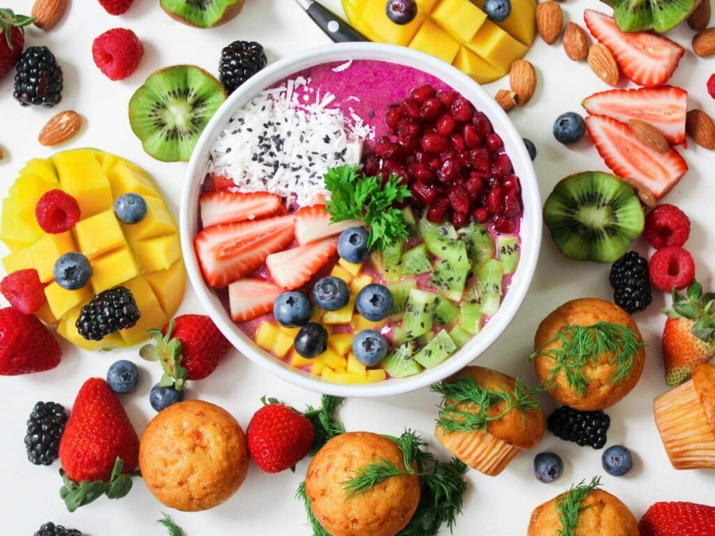 Ultimate Nutrition Guide visual with a vibrant assortment of healthy fruits and vegetables including cucumber, strawberries, and spinach, arranged on a clean plate.