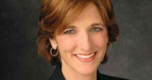 Jill Schlesinger smiling in professional portrait, discussing net worth