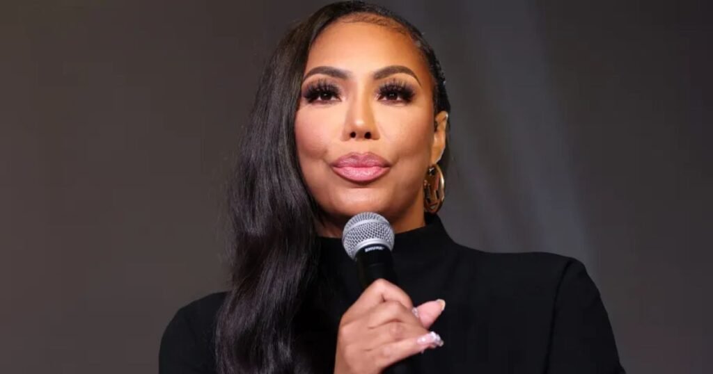 Tamar Braxton holding a microphone on stage