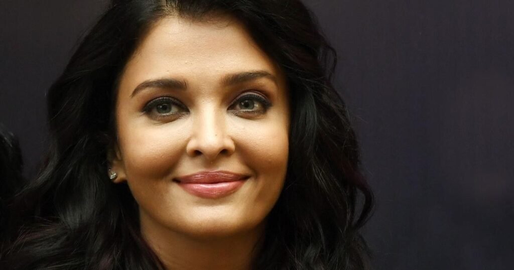 Aishwarya Rai smiling gracefully, showcasing her early modeling charm and timeless beauty.