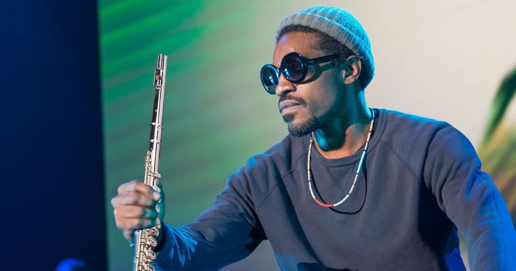 OutKast artist performing with a flute on stage, showcasing creative versatility in hip-hop expression.
